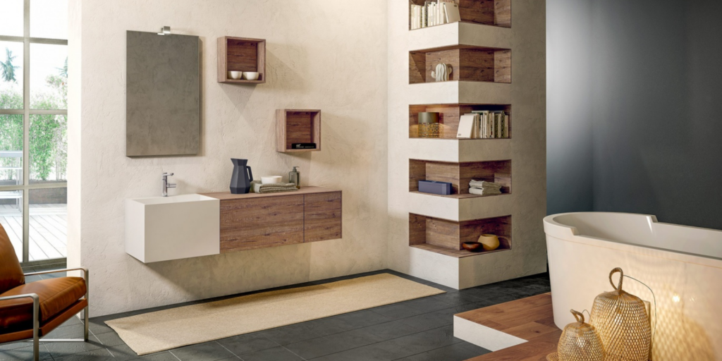 Light bathroom cabinet with freestanding tub, small vanity, shelves built in wall and floating shelves on the wall.